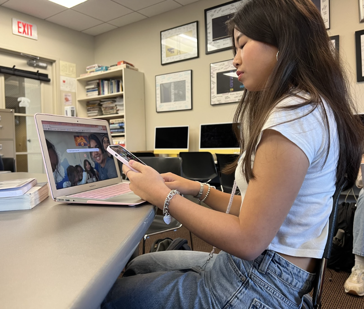 Helen Ren illustrates how students attempt to hide and use their phones during class. 